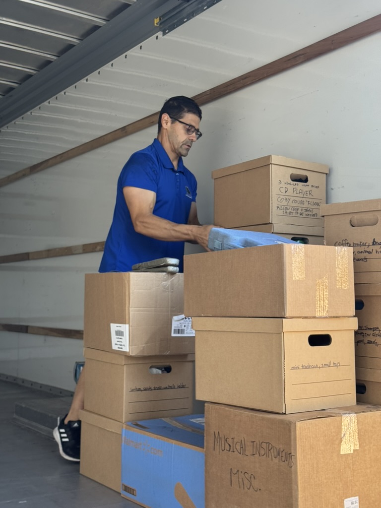 Toro mover loading labeled boxes into a truck