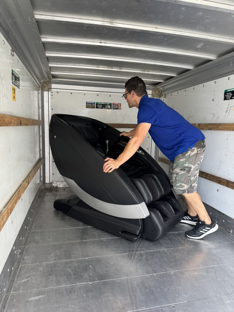 Toro mover lifting a heavy massage chair into the truck