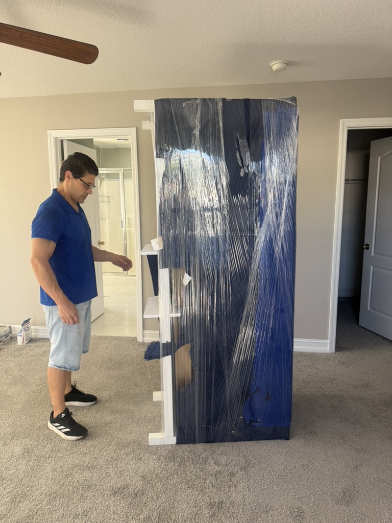 Toro Movers crew wrapping antique furniture in a historic Sanford home