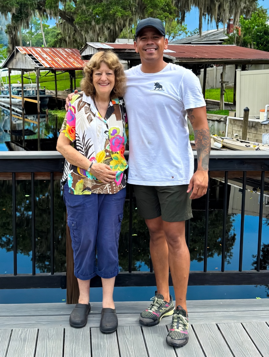 The Toro Movers family — owner in branded shirt with his mother on a Central Florida dock