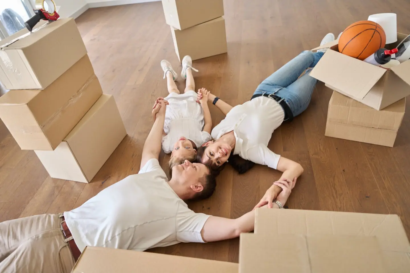 Couple relaxing among moving boxes after their Central Florida move with Toro Movers